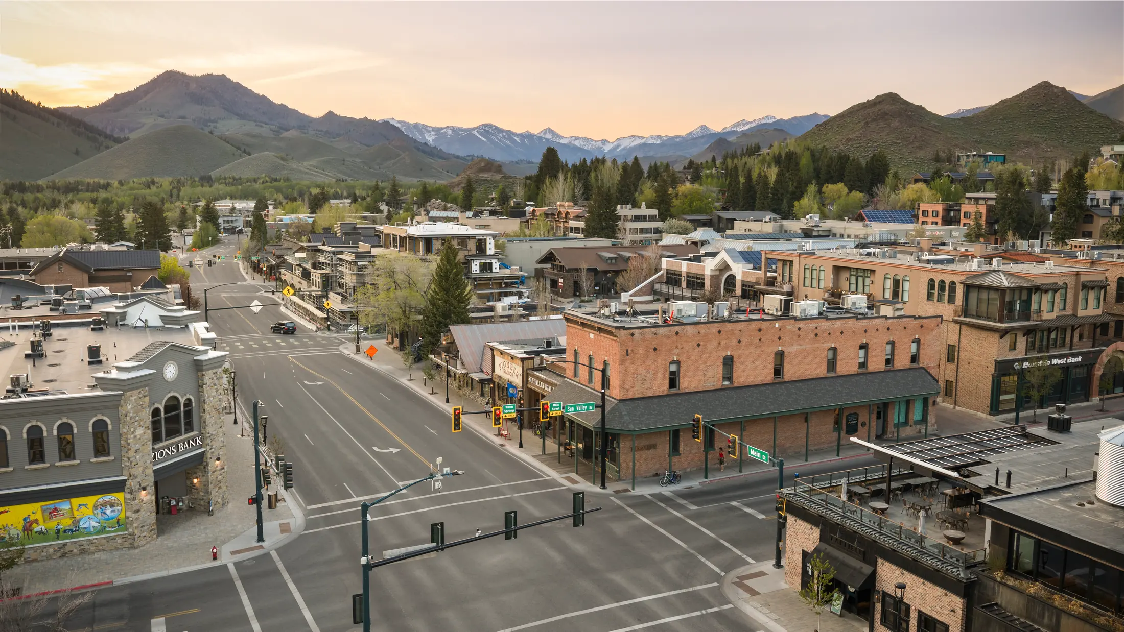 Downtown Ketchum streets and brick buildings beneath the surrounding mountain skyline.